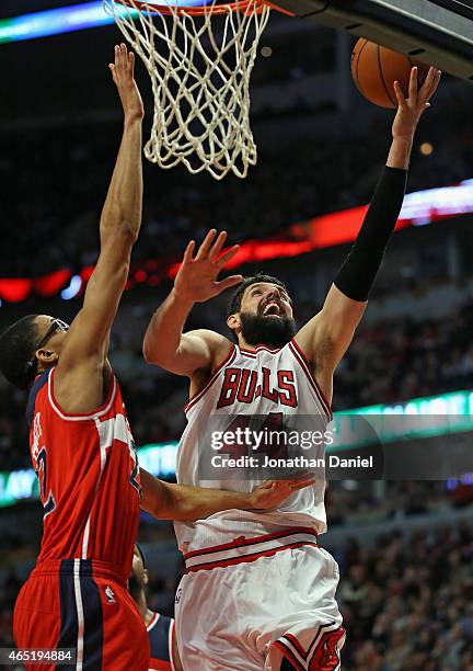 Nikola Mirotic of the Chicago Bulls puts up a shot against Otto Porter Jr. #22 of the Washington Wizards on his way to a game-high 23 points at the...
