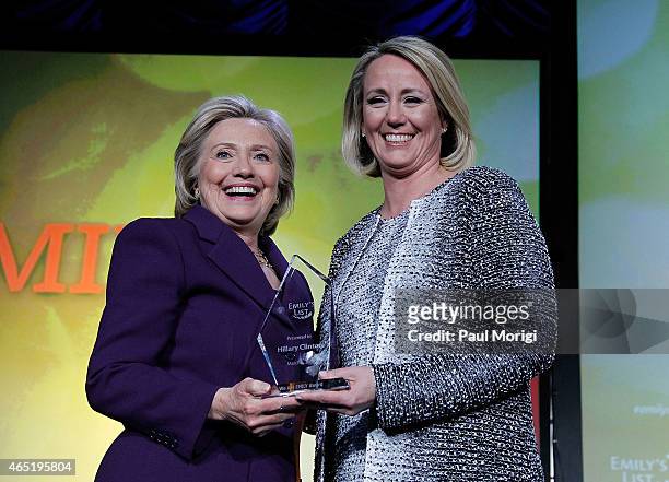 Former U.S. Secretary of State Hillary Clinton poses for a photo with EMILY's List President Stephanie Schriock after receiving the "We Are EMILY"...