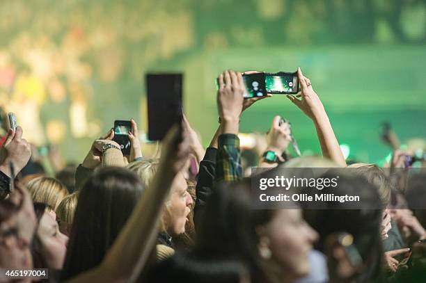 Music fans with mobile phone take photographs asof The Script performs at Nottingham Capital FM Arena on March 3, 2015 in Nottingham, England.