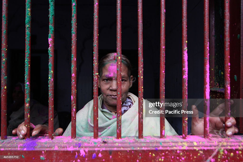 Indian Hindu widow look out from the window of their room as...