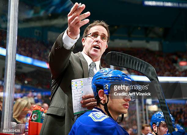 Assistant coach Doug Lidster of the Vancouver Canucks looks on from the bench during their NHL game against the St. Louis Blues at Rogers Arena March...