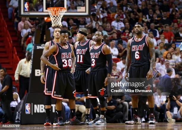 Michael Beasley, Norris Cole, Chris Andersen, Dwyane Wade and LeBron James of the Miami Heat look on during a game against the San Antonio Spurs at...