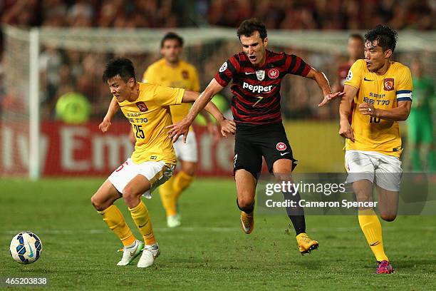 Labinot Haliti of the Wanderers is tackled during the Asian Champions League match between the Western Sydney Wanderers and Guangzhou Evergrande at...