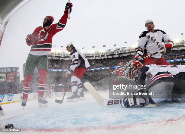 Patrik Elias of the New Jersey Devils scores a first period goal against Henrik Lundqvist of the New York Rangers during the 2014 Coors Light NHL...