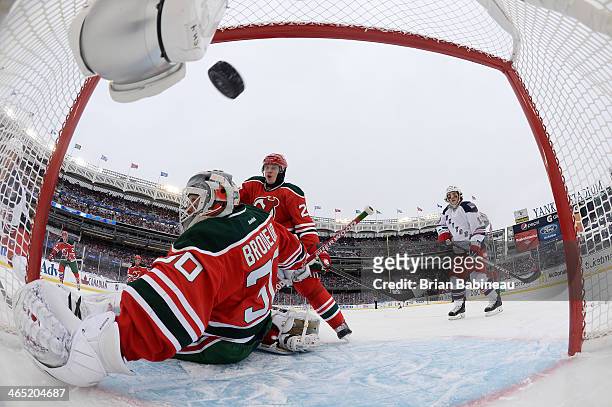 Dominic Moore of the New York Rangers scores a goal against Martin Brodeur of the New Jersey Devils in the first period of the 2014 Coors Light NHL...