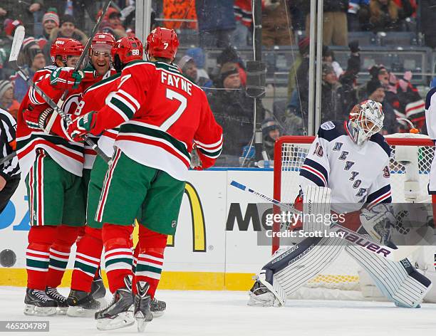 Travis Zajac of the New Jersey Devils celebrates with teammates following his first period goal against the New York Rangers during the 2014 Coors...