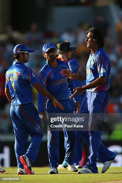 Shahpur Zadran of Afghanistan is congratulated after dismissing Steven Smith of Australia during the 2015 ICC Cricket World Cup match between...