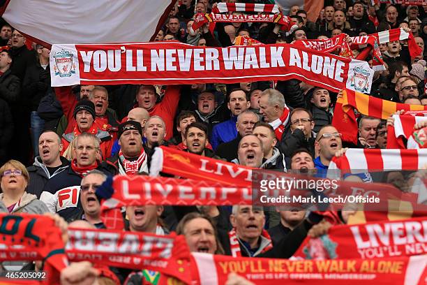 Liverpool fans hold their scarves aloft as they sing 'You'll Never Walk Alone' during the Barclays Premier League match between Liverpool and...