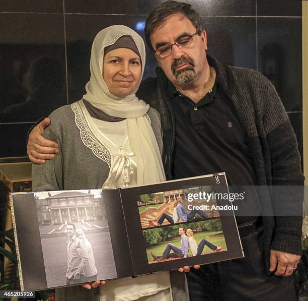 Leila Barakat , mother of shooting victim Deah Shaddy Barakat and her husband Namee Barakat show the photo album of their son after they speak to the...