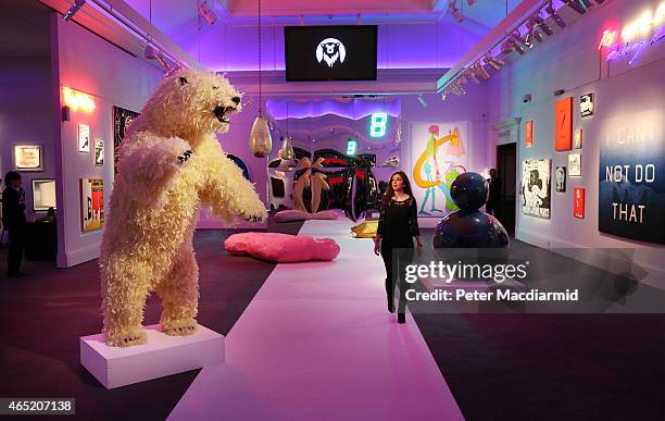 Giant bear entitled 'Life is Great' by artist Paola Pivi dominates the room of objects up for auction at Sotheby's Bear Witness collection on March...