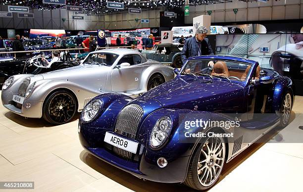 Visitor looks at a Morgan Aero 8 during the press day at the 85th Geneva International Motor Show on March 4, 2015 in Geneva, Switzerland. The...