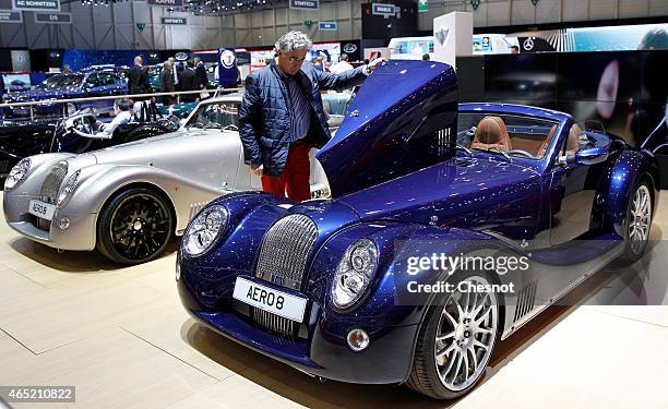 Visitor looks at a Morgan Aero 8 during the press day at the 85th Geneva International Motor Show on March 4, 2015 in Geneva, Switzerland. The...