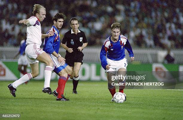 French Didier Deschamps and Eric Cantona fight for the ball on October 10, 1990 in Paris during the European Nation's cup qualifying match against...