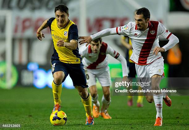 Cristian Rodriguez, alias El Cebolla, of Atletico de Madrid competes for the ball with Anaitz Arbilla of Rayo Vallecano de Madrid during the La Liga...