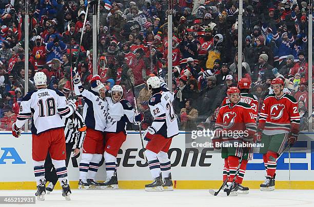 Dominic Moore of the New York Rangers celebrates his goal with Brian Boyle in the first period of the 2014 Coors Light NHL Stadium Series against the...