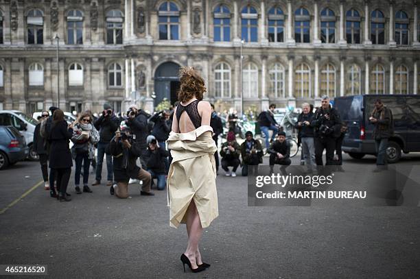 Model Leonore Masson poses outside Dries Van Noten 2015-2016 fall/winter ready-to-wear collection fashion show on March 4, 2015 in Paris. AFP PHOTO /...