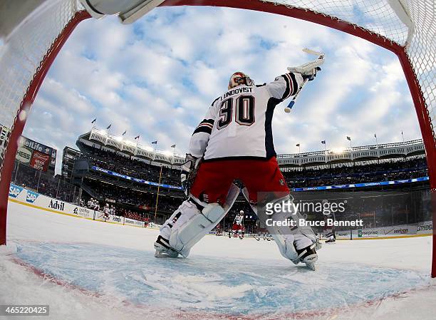 Henrik Lundqvist of the New York Rangers celebrates their 7 to 3 win over the New Jersey Devils during the 2014 Coors Light NHL Stadium Series at...