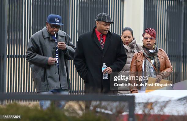 Michael Brown's mother, Lesley McSpadden, pictured at far right, leaves the FBI offices in St. Louis after meeting with federal officials on...