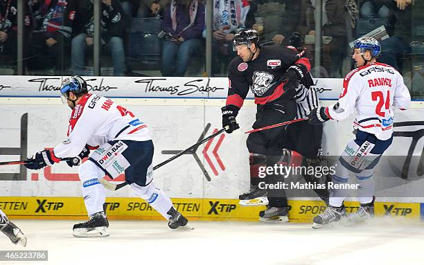 Henry Haase, Jason Jaspers of the Thomas Sabo Ice Tigers Nuernberg and Andre Rankel of the Eisbaeren Berlin during the DEL Ice Hockey match between...