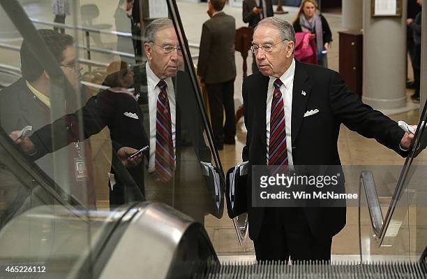 Sen. Chuck Grassley answers questions from reporters as he walks to the Senate chamber to vote on an attempt to override U.S. President Barack...