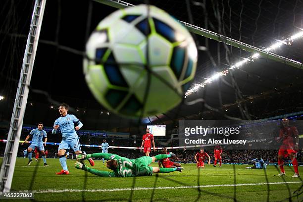David Silva of Manchester City scores the opening goal past goalkeeper Mark Schwarzer of Leicester City during the Barclays Premier League match...
