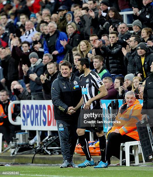 Newcastle United head coach John Carver hands Jonas Gutierrez of Newcastle United his comeback after recovering from cancer during the Barclays...