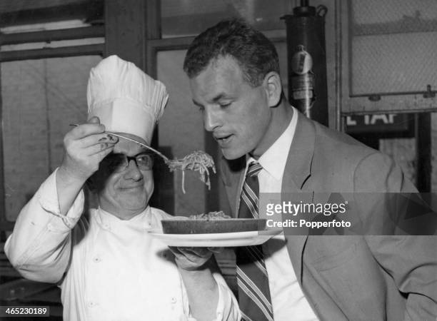 Welsh footballer John Charles is offered a plate of spaghetti at a hotel in Cheshire, 2nd October 1957. Charles is in the UK to play for Juventus...