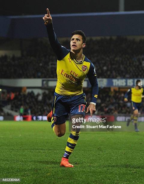 Alexis Sanchez celebrates scoring the 2nd Arsenal goal during the Barclays Premier League match between Queens Park Rangers and Arsenal at Loftus...