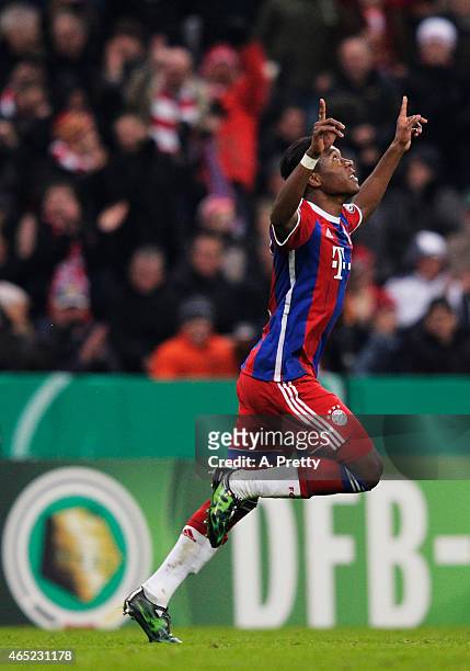 David Alaba of FC Bayern Muenchen celebrates scoring the first goal during the DFB Cup match between FC Bayern Muenchen and Eintracht Braunschweig at...