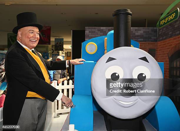 Bert Newton, dressed as The Fat Controller, cuts a Thomas the Tank birthday cake to celebrte the Thomas & Friends 70th Birthday Celebration at...