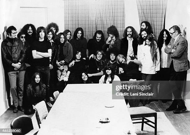 October 1968: Rock groups MC5 and The Stooges pose for a photo with friends and record executives as they both sign contracts with Electra Records in...