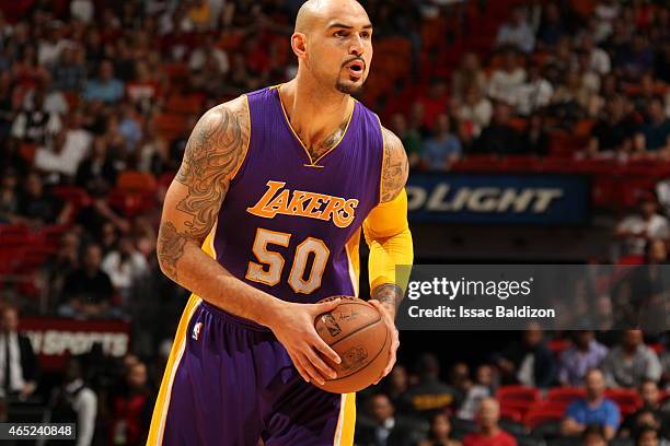 Robert Sacre of the Los Angeles Lakers handles the ball against the Miami Heat on March 4, 2015 at American Airlines Arena in Miami, Florida. NOTE TO...