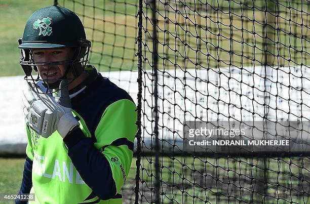 Ireland cricketer Alex Cusack adjusts his chin strap during a training session at the Bellerive Oval ground ahead of the 2015 Cricket World Cup Pool...
