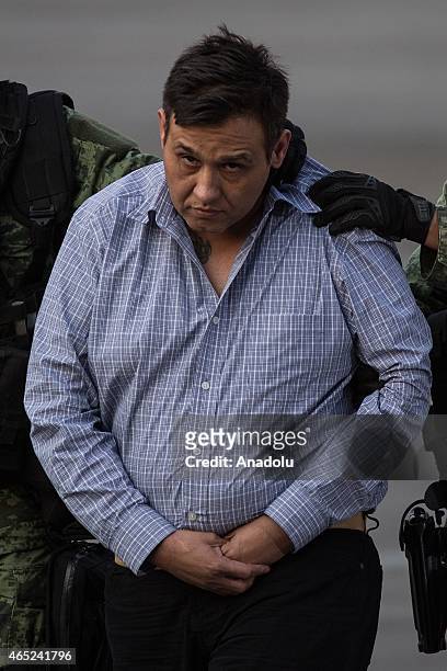 Soldiers escort a man who authorities identified as Omar Trevino Morales, alias "Z-42", leader of the criminal group "Los Zetas", at the Attorney...