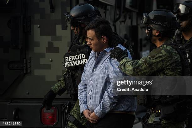 Soldiers escort a man who authorities identified as Omar Trevino Morales, alias "Z-42", leader of the criminal group "Los Zetas", at the Attorney...