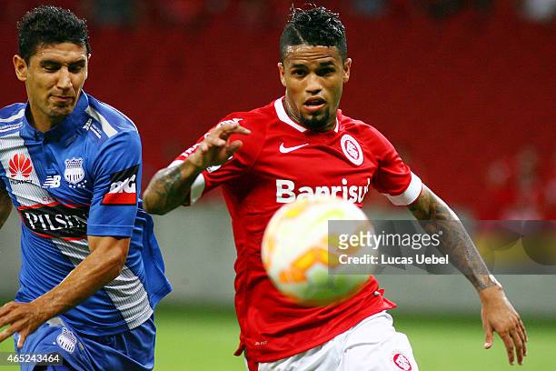Leo of Internacional battles for the ball against Oscar Bagui of Emelec during match between Internacional and Emelec as part of Copa Bridgestone...