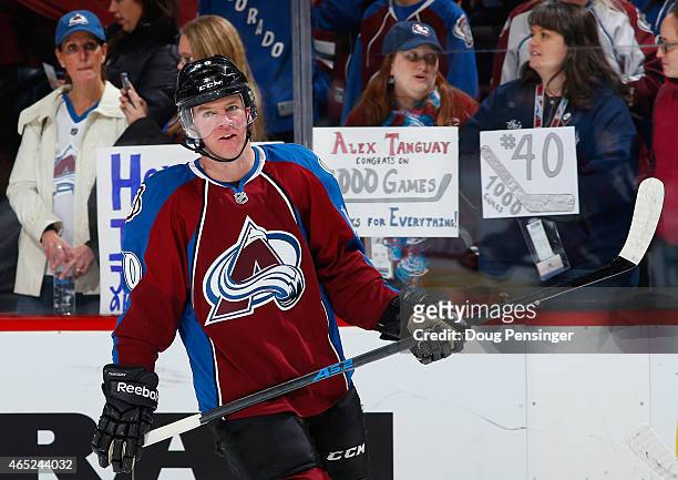 Fans display signs in support of Alex Tanguay of the Colorado Avalanche as he warms up to face the Pittsburgh Penguins in his 1000th career NHL game...