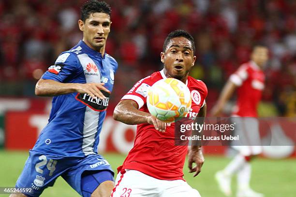 Jorge Henrique of Internacional battles for the ball against Fernando Gimenez of Emelec during match between Internacional and Emelec as part of Copa...