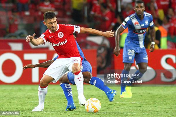 Alex of Internacional battles for the ball against Fernando Gimenez of Emelec during match between Internacional and Emelec as part of Copa...