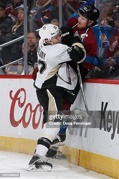 Ben Lovejoy of the Pittsburgh Penguins puts a hit on Gabriel Landeskog of the Colorado Avalanche at Pepsi Center on March 4, 2015 in Denver, Colorado.