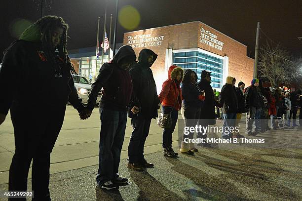 Protestors demonstrate outside the Ferguson Police Department in Ferguson, Missouri on March 4, 2015. The Federal Department of Justice decided today...