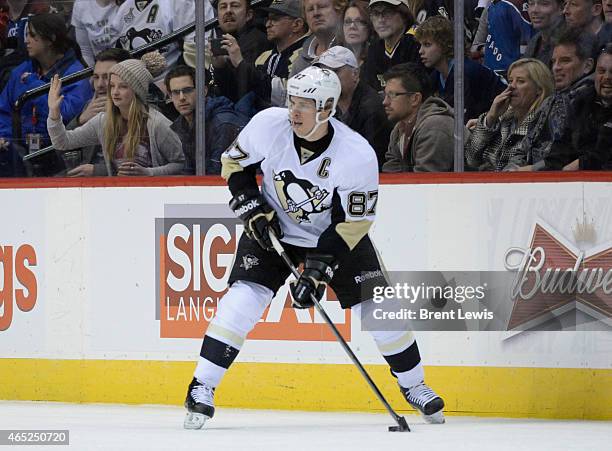 Pittsburgh Penguins center Sidney Crosby looks for an open teammate during the third period Wednesday, March 4, 2015 at the Pepsi Center in Denver,...