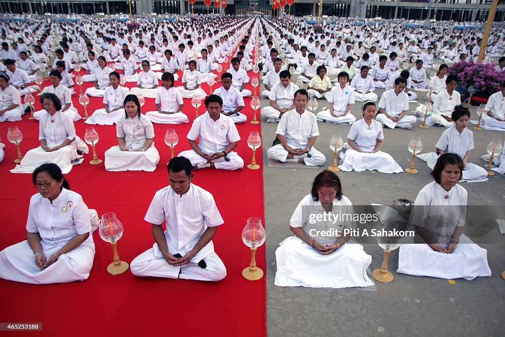 Thai Buddhist devotees meditate during a religious ceremony...