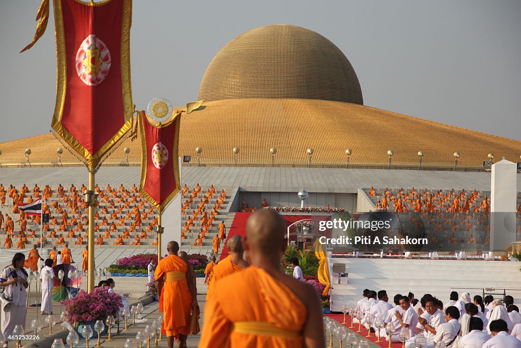 Thai Buddhist monks take part in the candle lighting...