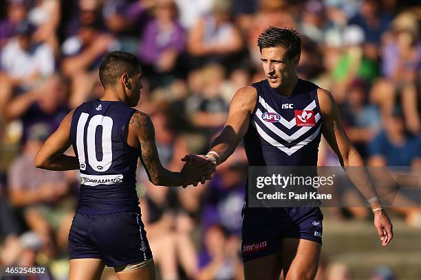 Matthew Pavlich and Michael Walters of the Dockers celebrate a goal during the NAB Challenge match between the Fremantle Dockers and the Melbourne...