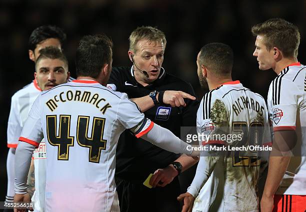 Referee, Trevor Kettle shows a yellow card to Jazz Richards of Fulham during the Sky Bet Championship match between Watford and Fulham at Vicarage...