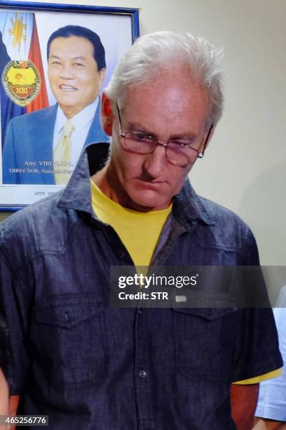 In this photo taken on February 21 Australian national Peter Scully , who allegedly sexually assaulted babies and children, stands while being...