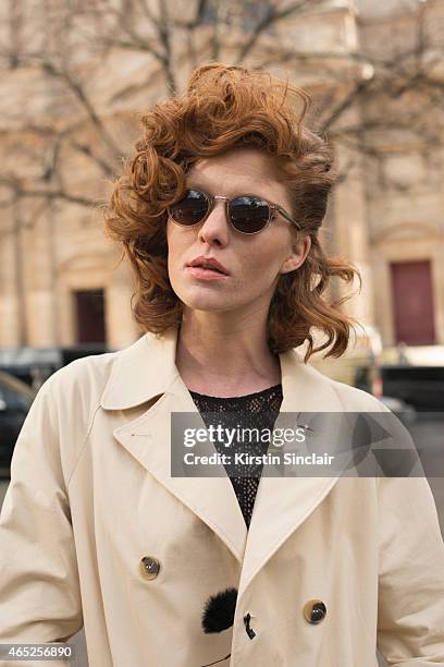 Model Leonore Masson wears Etam body, & Other Stories trench coat, and Cutler and Gross sunglasses on day 2 of Paris Collections: Women on March 04,...