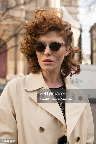 Model Leonore Masson wears Etam body, & Other Stories trench coat, and Cutler and Gross glasses on day 2 of Paris Collections: Women on March 04,...