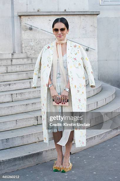 Stylist Tina Leung wears Rochas coat, dress and shoes and Dita sunglasses on day 2 of Paris Collections: Women on March 04, 2015 in Paris, France.